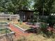 Backyard garden with multiple raised garden beds and a chicken coop at 704 S Mineral Springs Rd, Durham, NC 27703