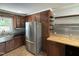 Well-equipped kitchen featuring dark wood cabinets, stainless steel appliances, and a window over the sink at 704 S Mineral Springs Rd, Durham, NC 27703