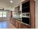 Bright kitchen with wooden cabinets, stainless steel oven, and hardwood floors at 704 S Mineral Springs Rd, Durham, NC 27703