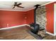 Cozy living room with a stone fireplace, wood burning stove, and wood-look flooring at 704 S Mineral Springs Rd, Durham, NC 27703