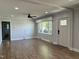 Spacious living room with hardwood floors, large windows, and modern gray walls at 704 S Mineral Springs Rd, Durham, NC 27703
