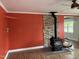 Bright living room features a black wood-burning stove with stone accent wall and wood flooring at 704 S Mineral Springs Rd, Durham, NC 27703