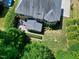 Aerial perspective showcasing a backyard with mature trees, patio, porch, and lush green lawn at 713 Liberty Cliff Dr, Cary, NC 27519