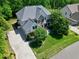 Aerial shot of the house showing its manicured lawn, trees, driveway with basketball court and architectural details at 713 Liberty Cliff Dr, Cary, NC 27519