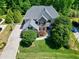 Bird's eye view of a well-maintained home with mature trees, lush lawn, and spacious driveway at 713 Liberty Cliff Dr, Cary, NC 27519