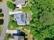 Stunning aerial view of a home with lush landscaping, patio area, and mature trees at 713 Liberty Cliff Dr, Cary, NC 27519