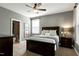 Comfortable bedroom with a ceiling fan, natural light, and neutral carpet at 713 Liberty Cliff Dr, Cary, NC 27519