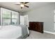 Bright bedroom with a large window, neutral carpet, and a ceiling fan at 713 Liberty Cliff Dr, Cary, NC 27519