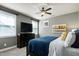 Cozy bedroom with grey walls, carpet, ceiling fan, and a dresser under a mounted TV at 713 Liberty Cliff Dr, Cary, NC 27519