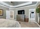 Neutral bedroom with coffered ceiling, dresser and television at 713 Liberty Cliff Dr, Cary, NC 27519