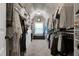 Spacious walk-in closet featuring custom shelving, drawers, and ample hanging space for organized storage at 713 Liberty Cliff Dr, Cary, NC 27519