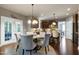 A dining area featuring a round table, a chandelier, and access to the kitchen and outdoor patio at 713 Liberty Cliff Dr, Cary, NC 27519