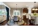 Dining area featuring a round table, French doors, hardwood floors, and an open flow to kitchen at 713 Liberty Cliff Dr, Cary, NC 27519