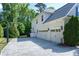 Spacious driveway leading to a three-car garage with a basketball hoop and well-maintained landscaping at 713 Liberty Cliff Dr, Cary, NC 27519