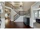 Stately foyer with beautiful hardwood floors, a staircase, and neutral paint at 713 Liberty Cliff Dr, Cary, NC 27519