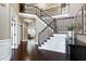 Elegant foyer featuring a grand staircase, hardwood floors, and natural lighting at 713 Liberty Cliff Dr, Cary, NC 27519