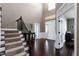 Grand two story foyer with hardwood floors, staircase, and double front doors at 713 Liberty Cliff Dr, Cary, NC 27519