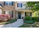 Inviting front entrance with stone columns, a charming door, and manicured landscaping at 713 Liberty Cliff Dr, Cary, NC 27519