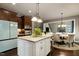 Well-appointed kitchen with granite island, modern appliances, and seamless flow into the dining area at 713 Liberty Cliff Dr, Cary, NC 27519