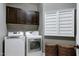 Functional laundry room equipped with modern washer, dryer, and overhead cabinets at 713 Liberty Cliff Dr, Cary, NC 27519