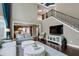 An elegant living room features a staircase, high ceilings, and seamless flow to the kitchen area at 713 Liberty Cliff Dr, Cary, NC 27519