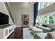A bright, airy living room featuring a stone fireplace and large windows with luxurious, comfortable furniture at 713 Liberty Cliff Dr, Cary, NC 27519