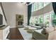 A spacious living room boasts a stone fireplace, a wall of windows, and elegant, high ceilings at 713 Liberty Cliff Dr, Cary, NC 27519