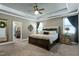 Cozy main bedroom with tray ceiling, ceiling fan, and ensuite bathroom at 713 Liberty Cliff Dr, Cary, NC 27519