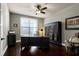 Home office with hardwood floors, custom shelves, and natural lighting at 713 Liberty Cliff Dr, Cary, NC 27519