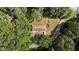 Aerial view of the residence shows a long driveway, large trees, and landscaped areas at 725-727 Locust Ln, Raleigh, NC 27603
