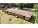 Aerial view of the brick home featuring a sprawling lawn and mature trees, offering privacy and curb appeal at 725-727 Locust Ln, Raleigh, NC 27603