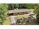 Aerial shot showcasing the duplex, mature trees, driveways, outbuildings, and a PODS moving container at 725-727 Locust Ln, Raleigh, NC 27603