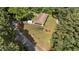Aerial view of home surrounded by trees, featuring a long driveway and lush landscaping at 725-727 Locust Ln, Raleigh, NC 27603
