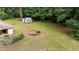 Aerial view of the backyard featuring a fire pit and storage building at 725-727 Locust Ln, Raleigh, NC 27603