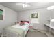 Comfortable bedroom featuring a ceiling fan, natural light, and neutral decor at 725-727 Locust Ln, Raleigh, NC 27603