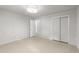 Neutral bedroom featuring a ceiling light and a double door closet at 725-727 Locust Ln, Raleigh, NC 27603