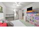 Bright bedroom featuring a ceiling fan, closet space, and a side door at 725-727 Locust Ln, Raleigh, NC 27603