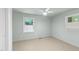 Light and airy bedroom featuring two windows and a ceiling fan at 725-727 Locust Ln, Raleigh, NC 27603