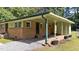Angle view of unit 727 showing the carport, small back porch and well-manicured lawn at 725-727 Locust Ln, Raleigh, NC 27603