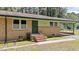 Street view of the duplex with well-maintained front yard, covered carport, and brick facade at 725-727 Locust Ln, Raleigh, NC 27603