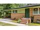 Inviting front entrance of unit 725 with brick steps, a secure door, and a covered carport at 725-727 Locust Ln, Raleigh, NC 27603
