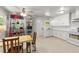 Bright kitchen featuring white cabinets, modern appliances, and a dining area at 725-727 Locust Ln, Raleigh, NC 27603