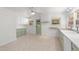 A bright kitchen with light-green cabinets and lots of windows at 725-727 Locust Ln, Raleigh, NC 27603