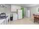 Kitchen featuring white appliances, white cabinets, a dining area and washer and dryer at 725-727 Locust Ln, Raleigh, NC 27603