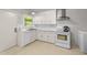Functional kitchen featuring white cabinets, marble countertops, and modern appliances at 725-727 Locust Ln, Raleigh, NC 27603