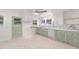 A bright kitchen with light-green cabinets and lots of windows at 725-727 Locust Ln, Raleigh, NC 27603
