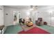 Comfortable living room featuring a ceiling fan, floral sofa, and wood block coffee table with area rug at 725-727 Locust Ln, Raleigh, NC 27603