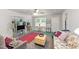 Cozy living room featuring a ceiling fan, comfortable floral sofa, and unique wood block coffee table at 725-727 Locust Ln, Raleigh, NC 27603