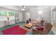 Bright living room featuring a ceiling fan, comfortable floral sofa, and wood block coffee table at 725-727 Locust Ln, Raleigh, NC 27603