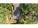 Aerial perspective of the home showcasing the roof, backyard with a patio, and surrounding greenery and trees at 7918 Yester Ct, Raleigh, NC 27615